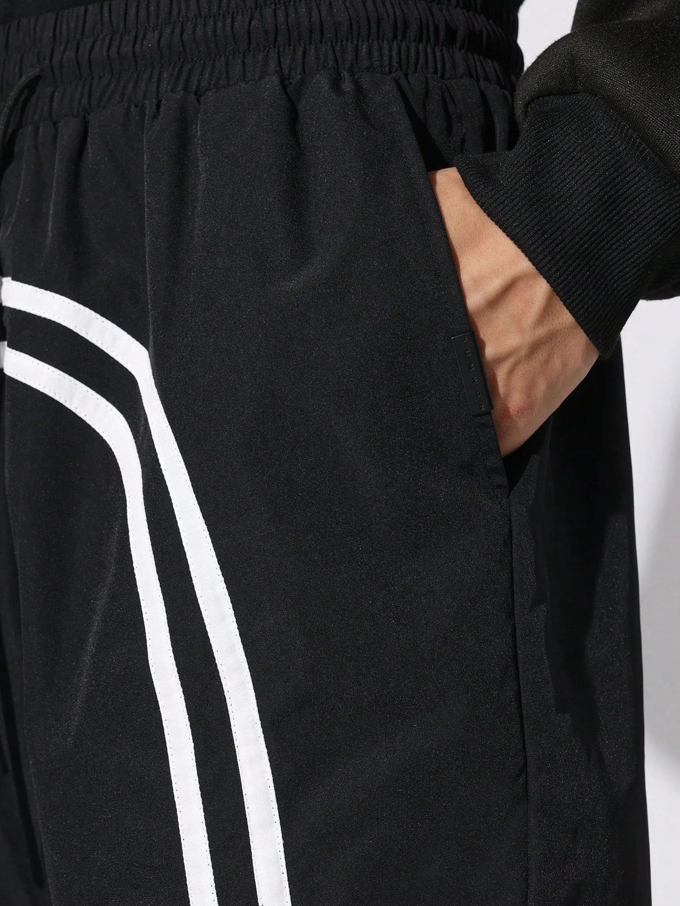 Person wearing black Nylon Race Shorts
