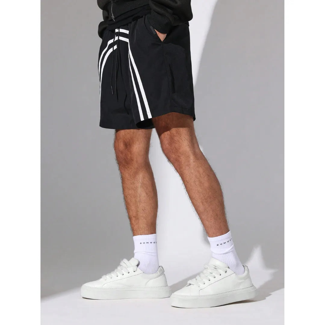 Person wearing black Nylon Race Shorts