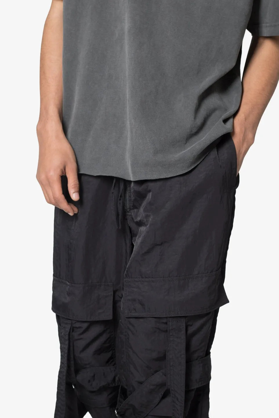 Person wearing black baggy strap cargo pants 
