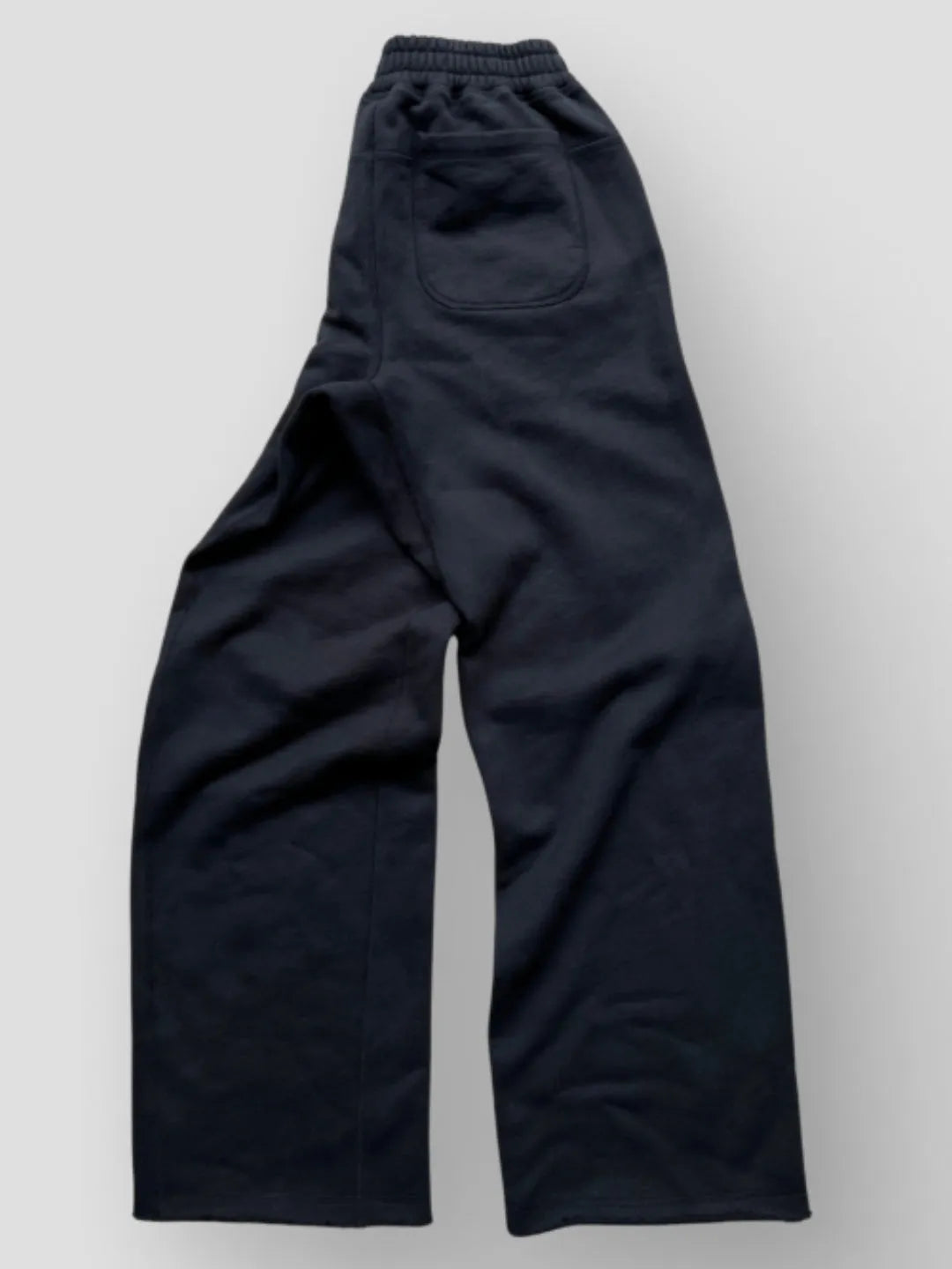 Person wearing button up black sweatpants 