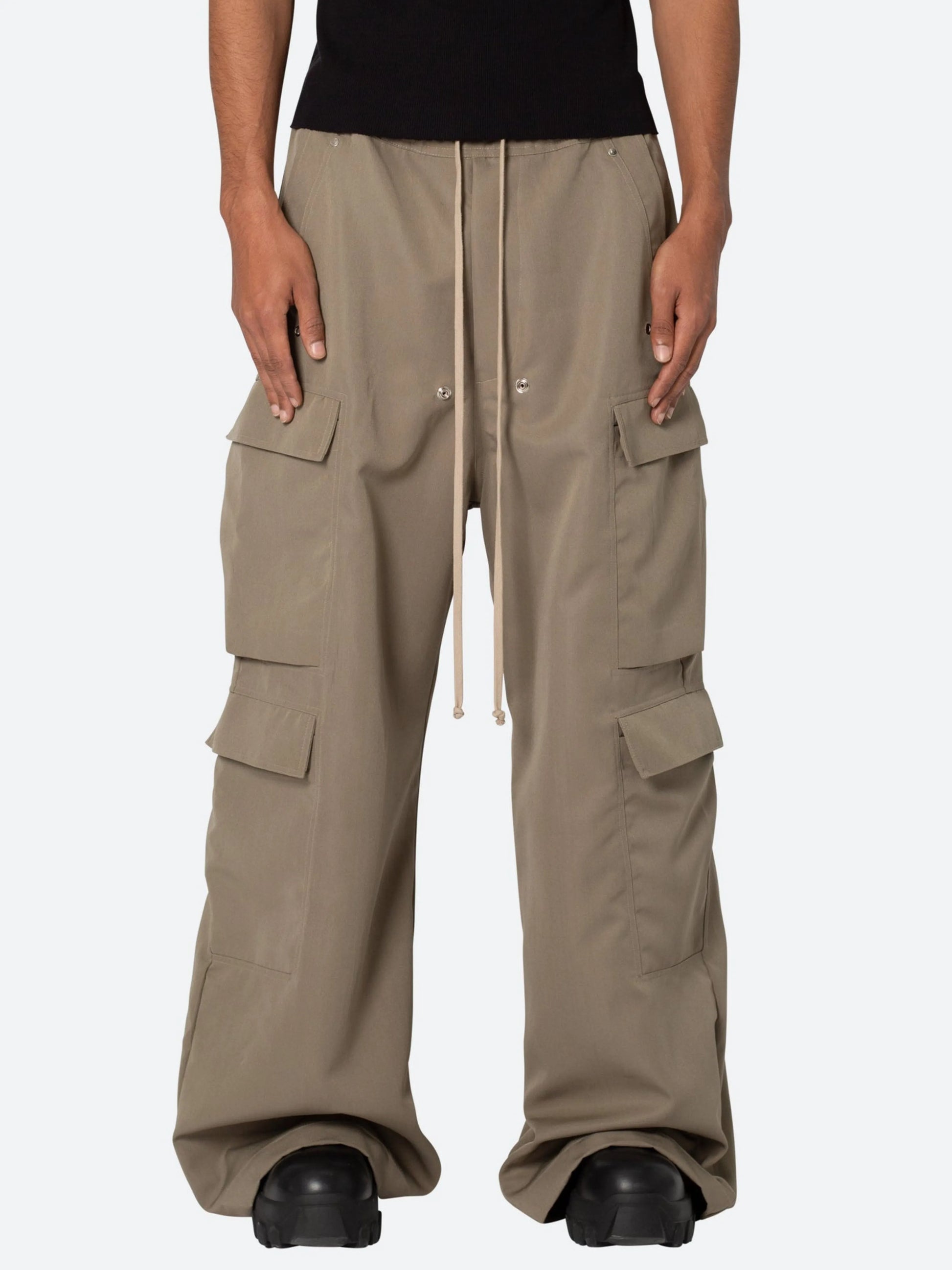 Beige cargo pants worn by a person on a white background