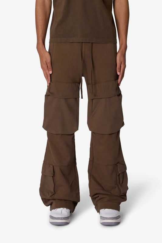 Brown cargo pants worn by a person on a white background