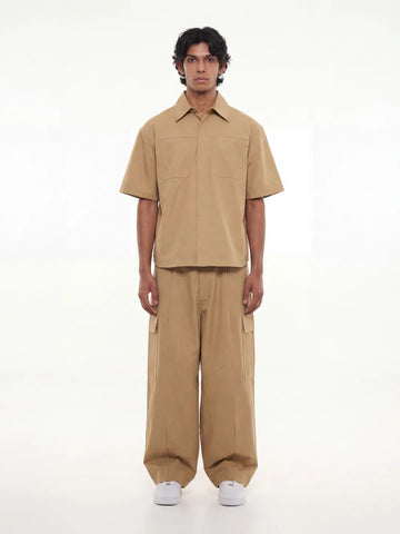 Man wearing a beige outfit on a white background