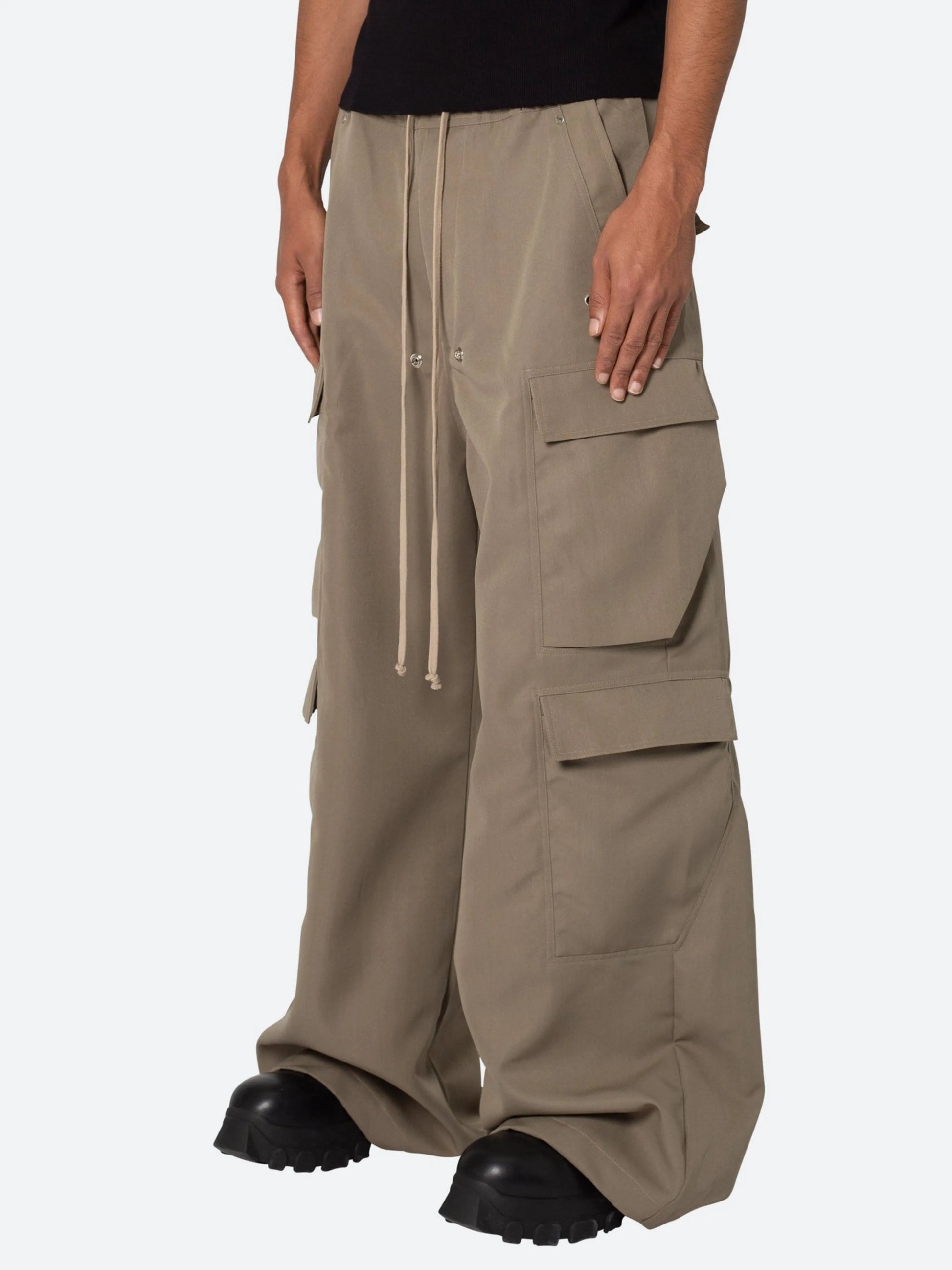 Beige cargo pants worn by a person on a white background
