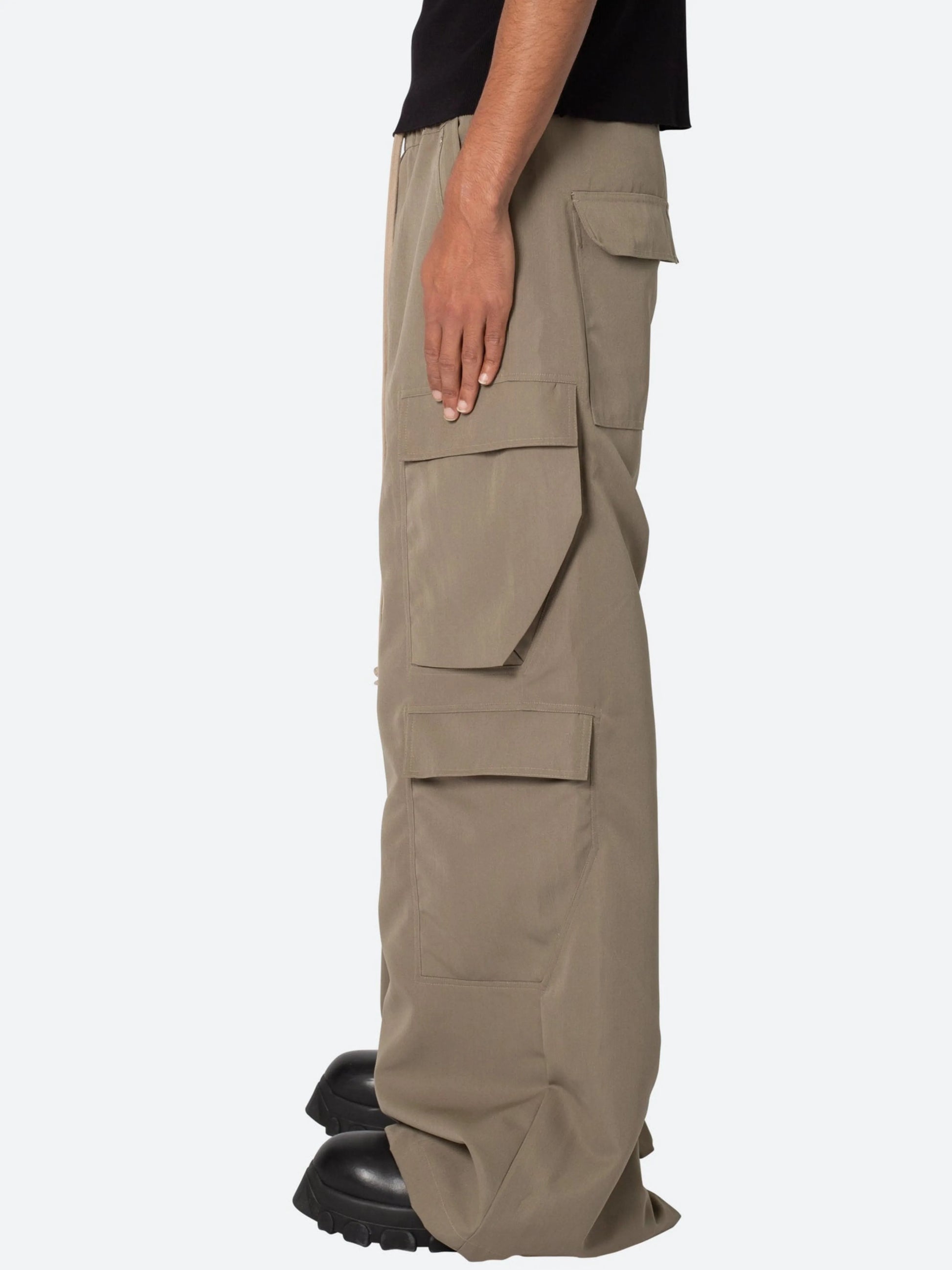 Beige cargo pants worn by a person on a white background