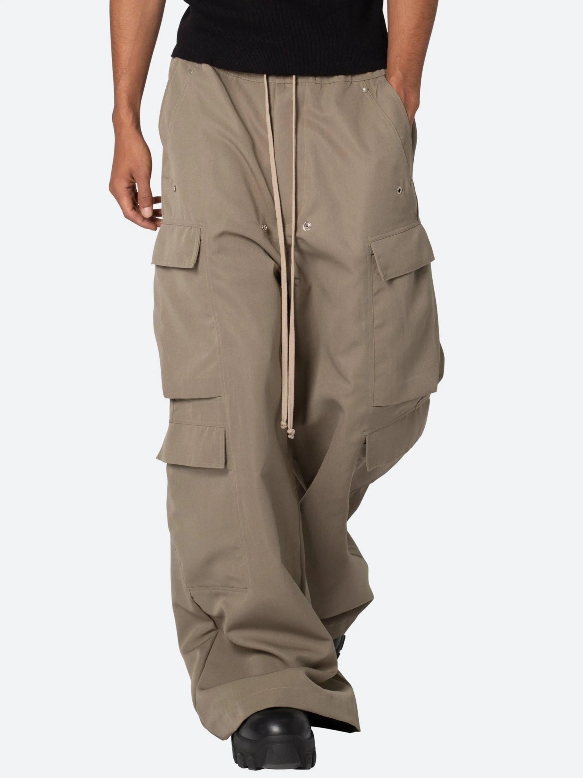 Beige cargo pants worn by a person on a white background