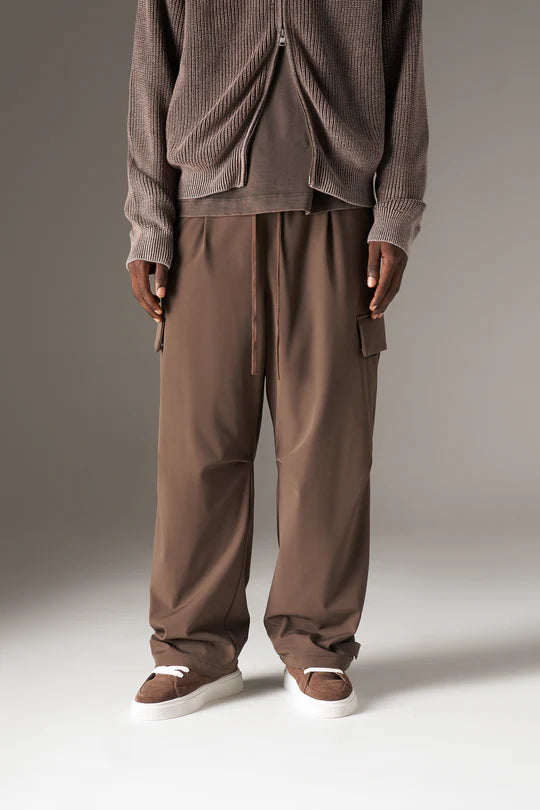 Kyoto Brown Cargo Pant is a modern utility essential designed with a relaxed wide-leg silhouette for effortless everyday wear. Crafted with a technical, structured fabric, these cargo pants balance durability with comfort, making them ideal for contemporary streetwear and elevated casual styling.