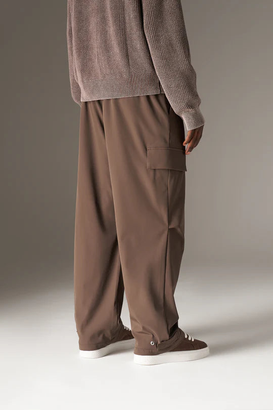 Kyoto Brown Cargo Pant is a modern utility essential designed with a relaxed wide-leg silhouette for effortless everyday wear. Crafted with a technical, structured fabric, these cargo pants balance durability with comfort, making them ideal for contemporary streetwear and elevated casual styling.
