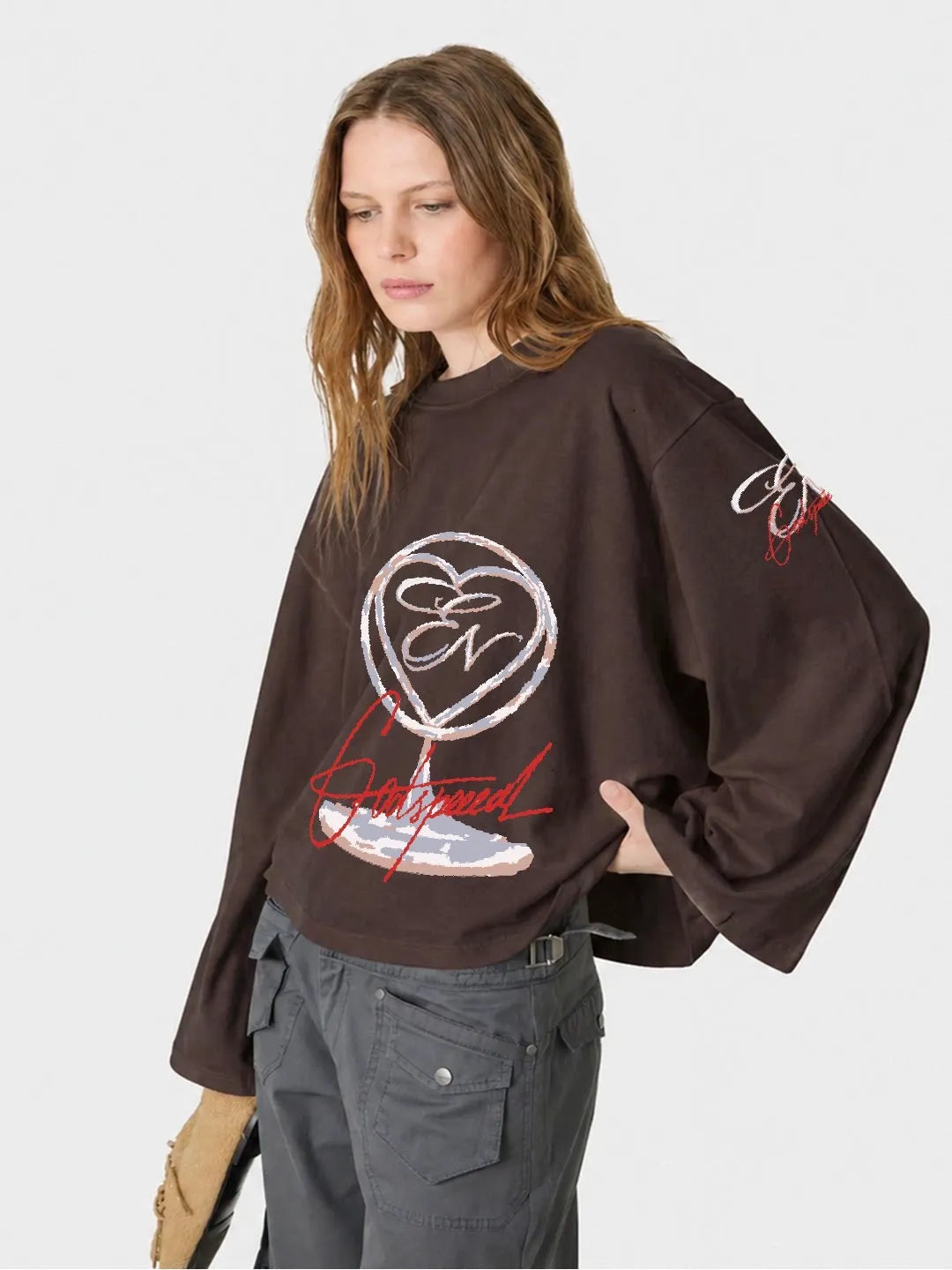 Person wearing a full sleeve oversized t-shirt with a heart design and text on a white background