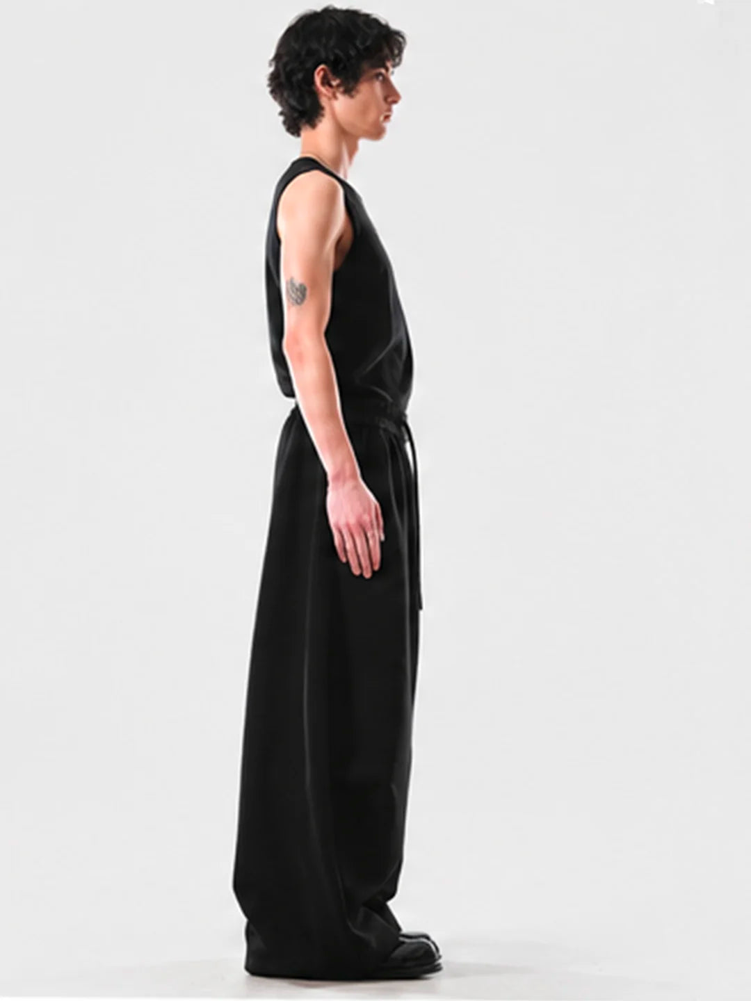 Person wearing a black sweats on a white background