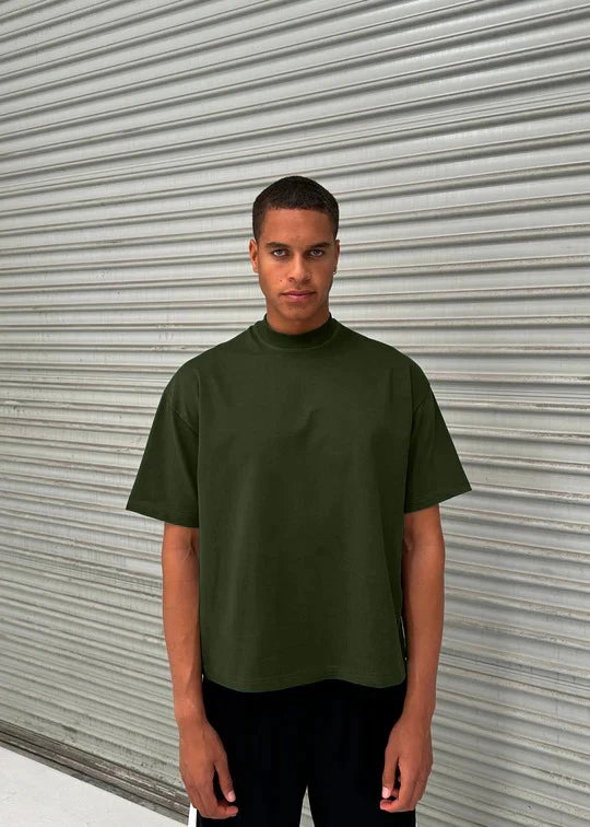 Man wearing an olive green turtleneck t-shirt 