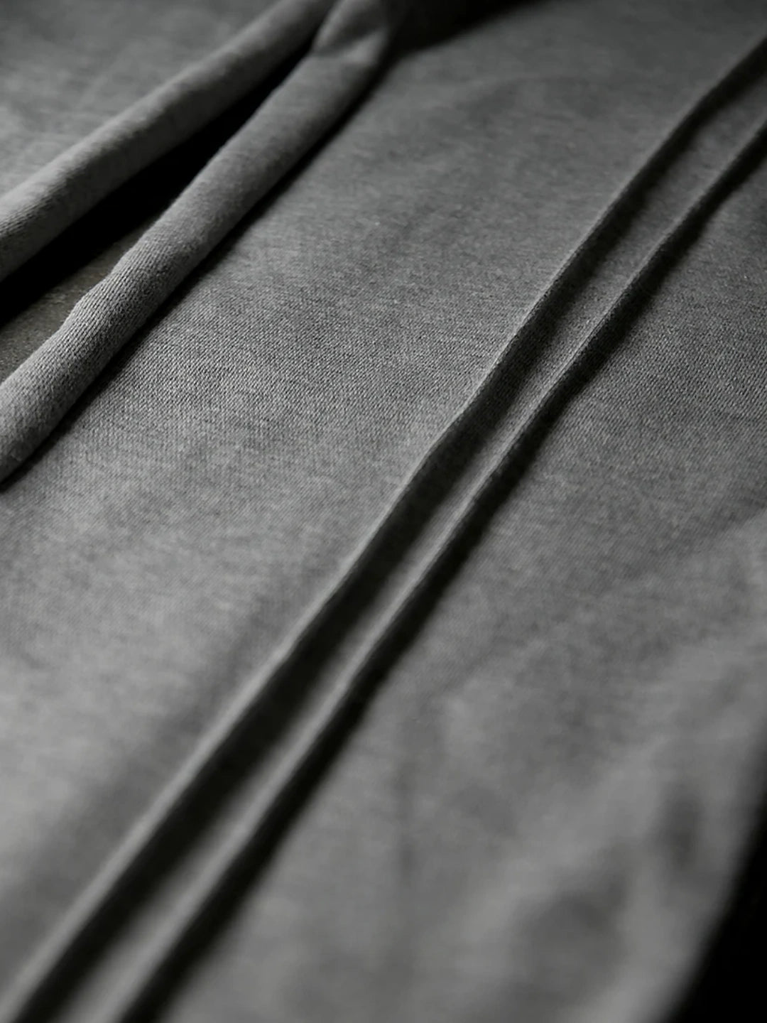 Close-up of dark grey fabric with folds