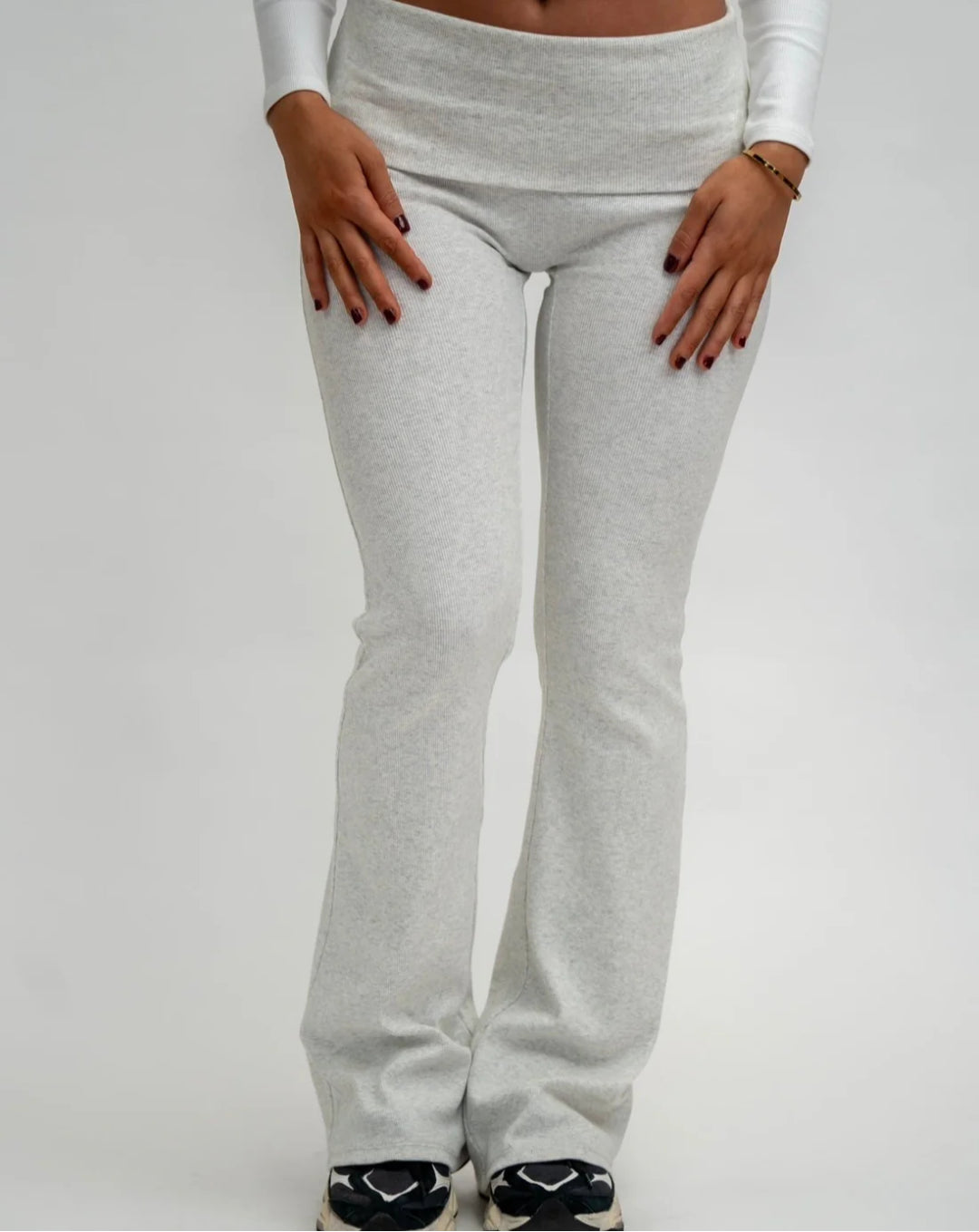 Grey sweatpants worn by a person on a white background