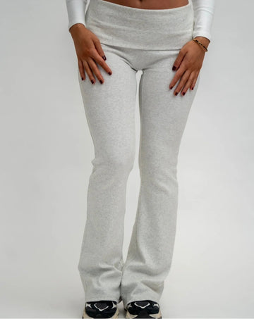 Grey sweatpants worn by a person on a white background
