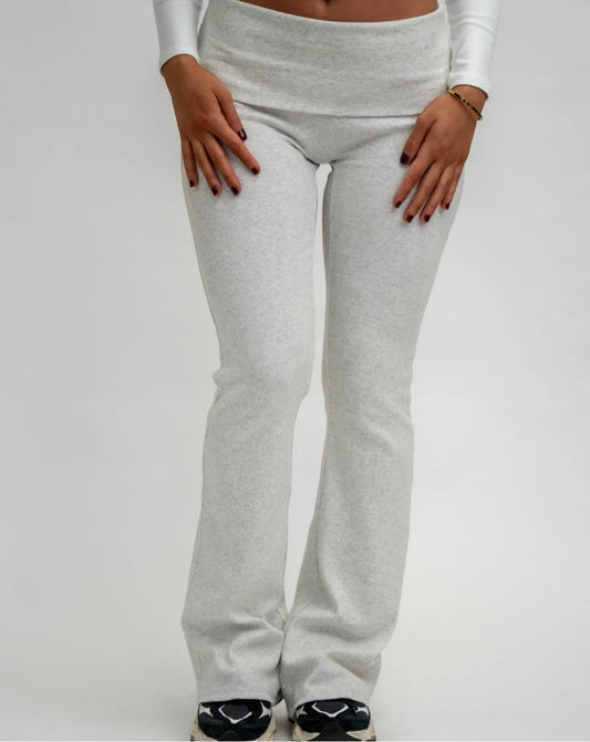 Grey sweatpants worn by a person on a white background