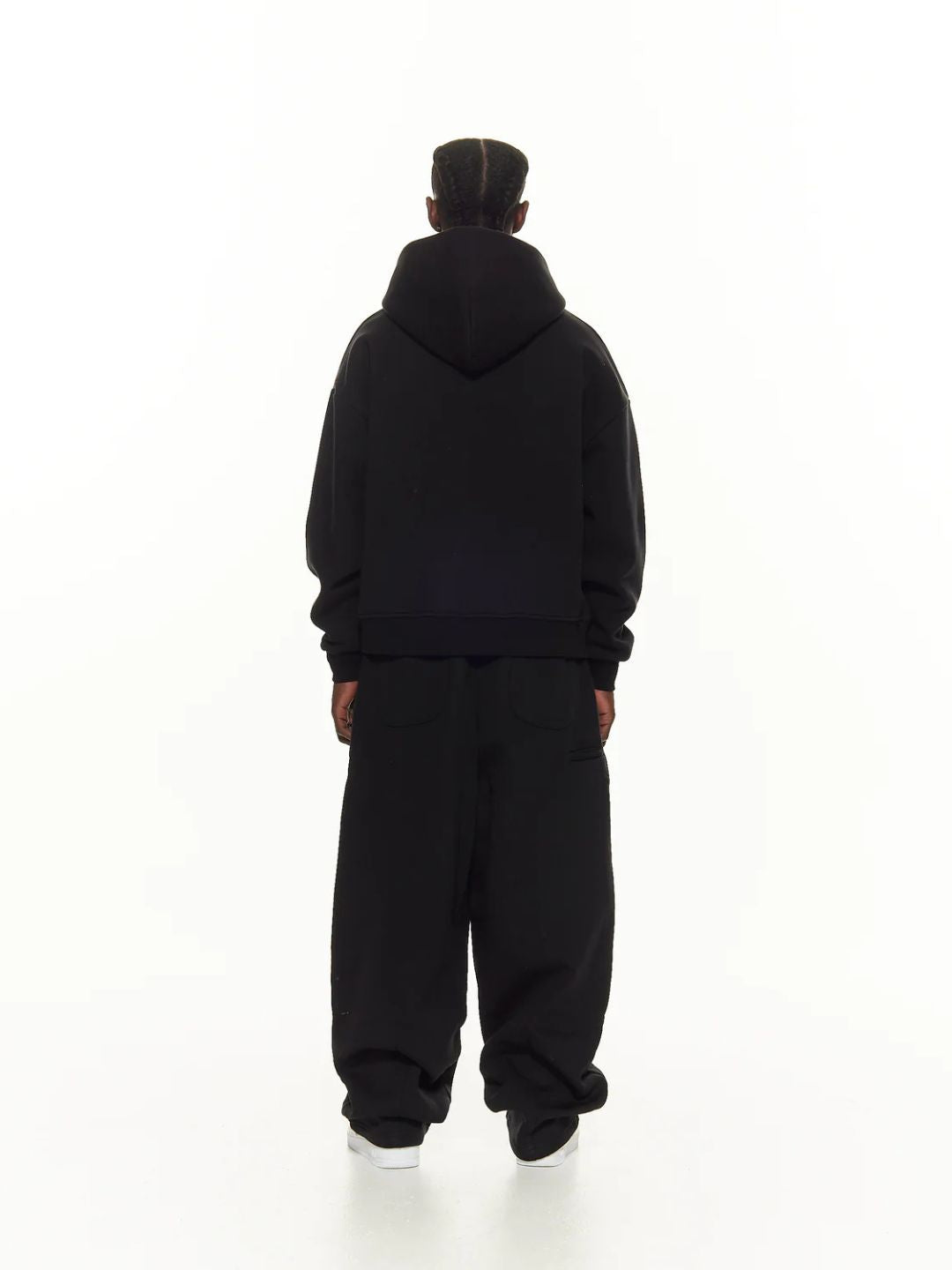 Person wearing a black sweatpants on a white background