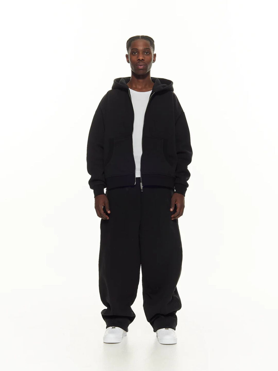 Person wearing a black sweatpants on a white background