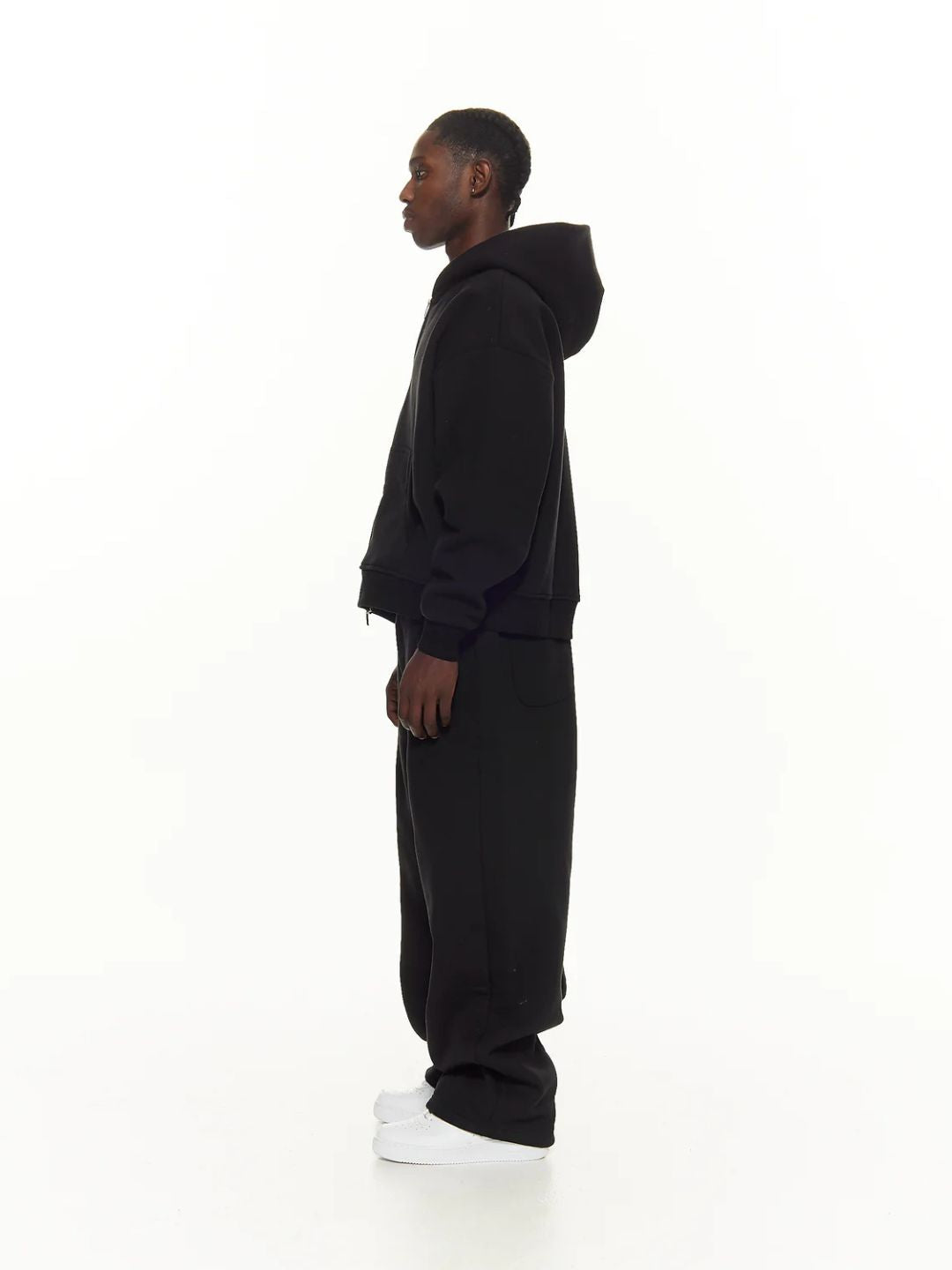 Person wearing a black sweatpants on a white background