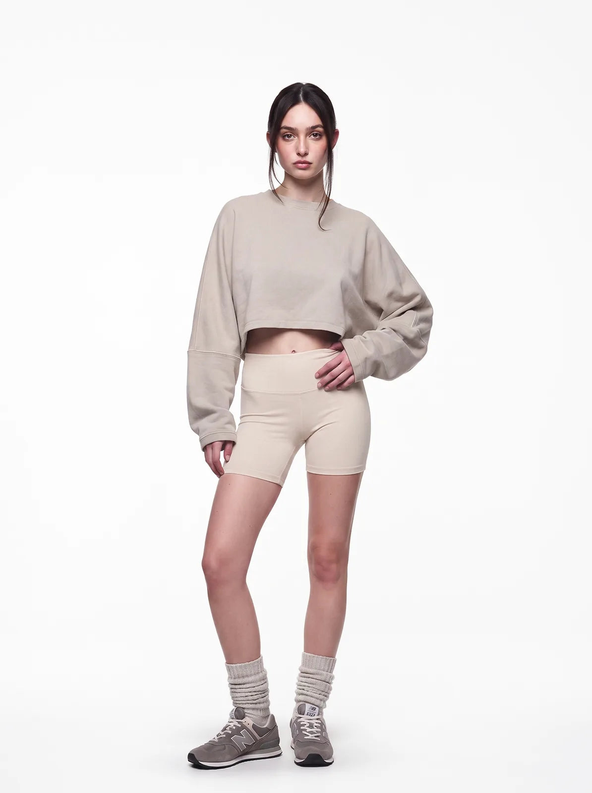 Woman wearing sand color cult cover crop tee