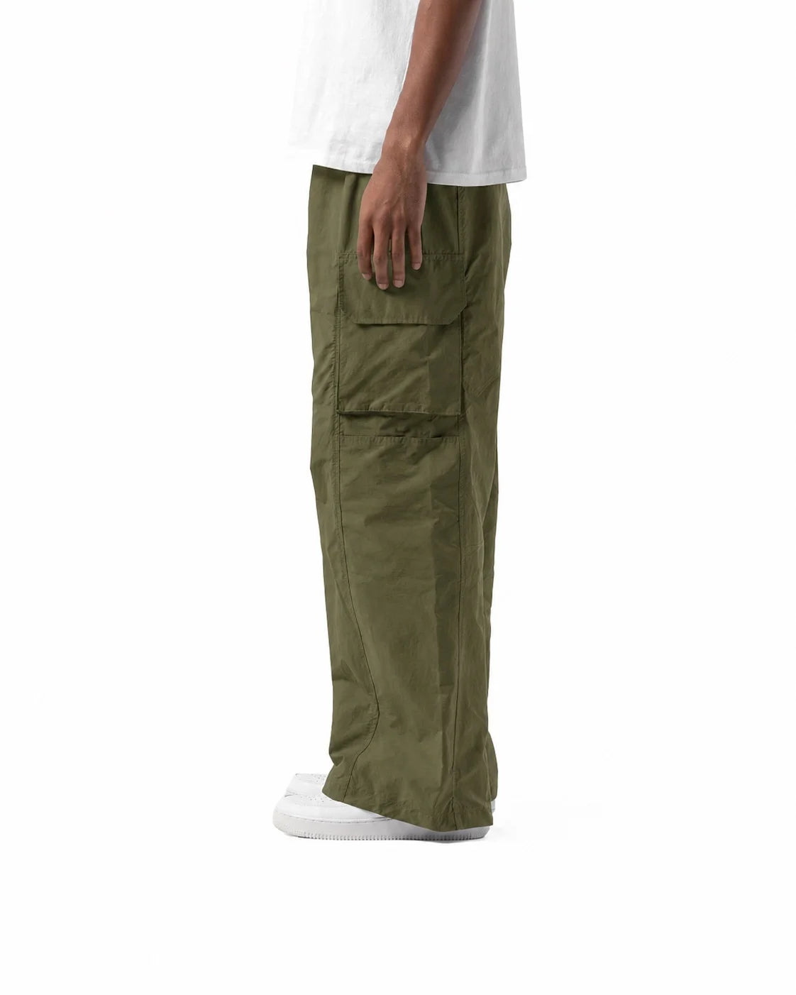 Person wearing olive green cargo pants on a white background