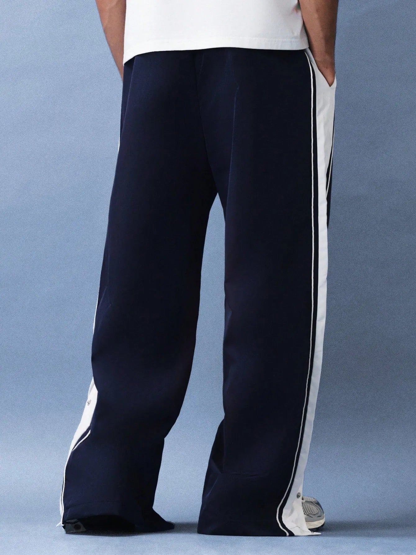 Navy pants with white stripes on a plain background