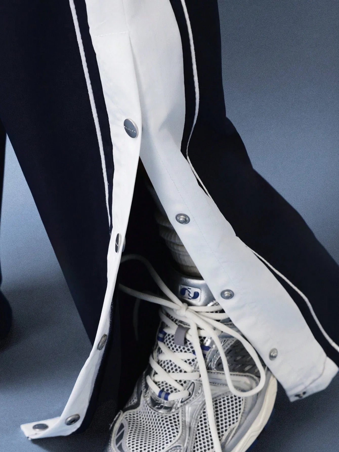 Navy pants with white stripes on a plain background