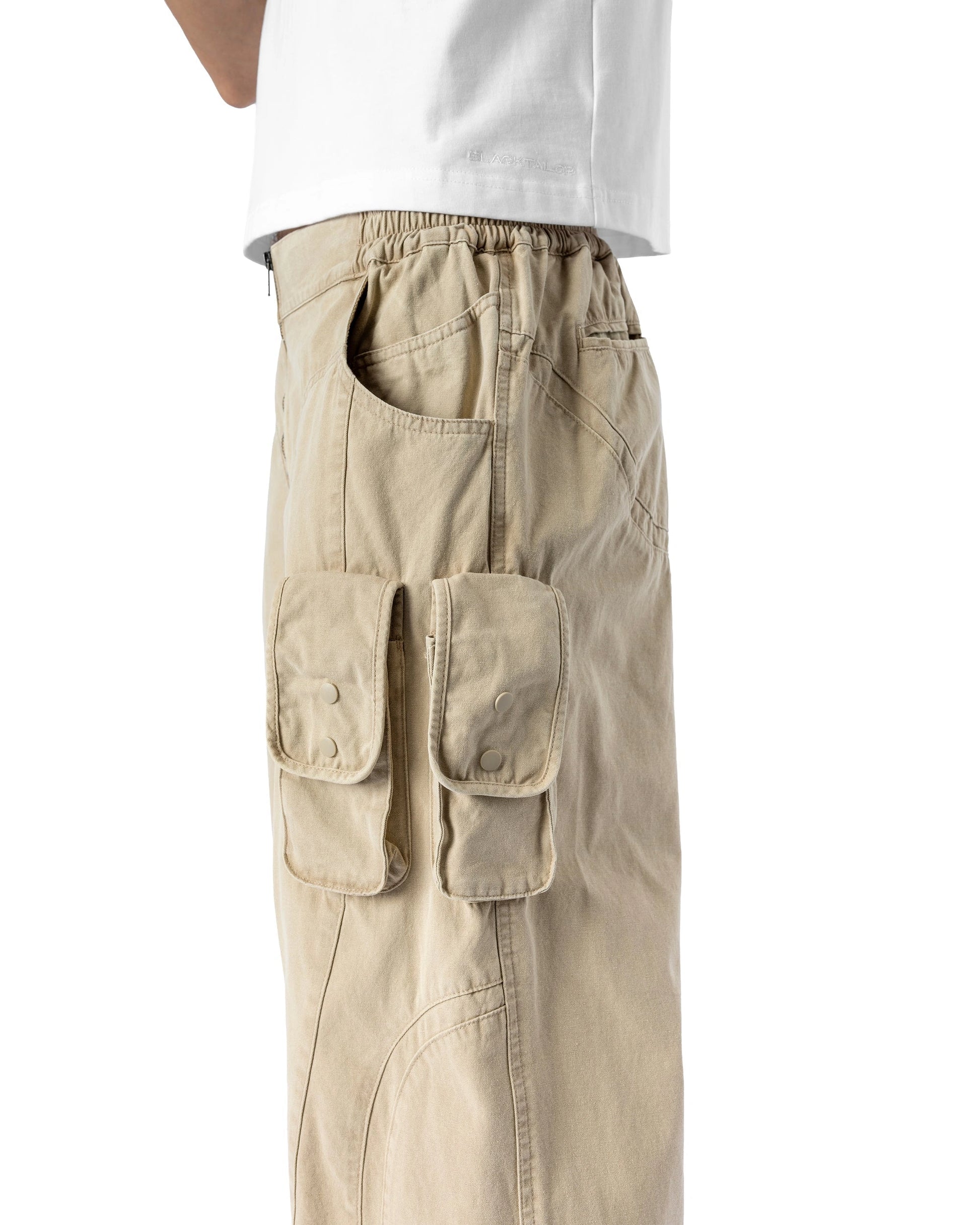 Beige cargo pants worn by a person on a white background