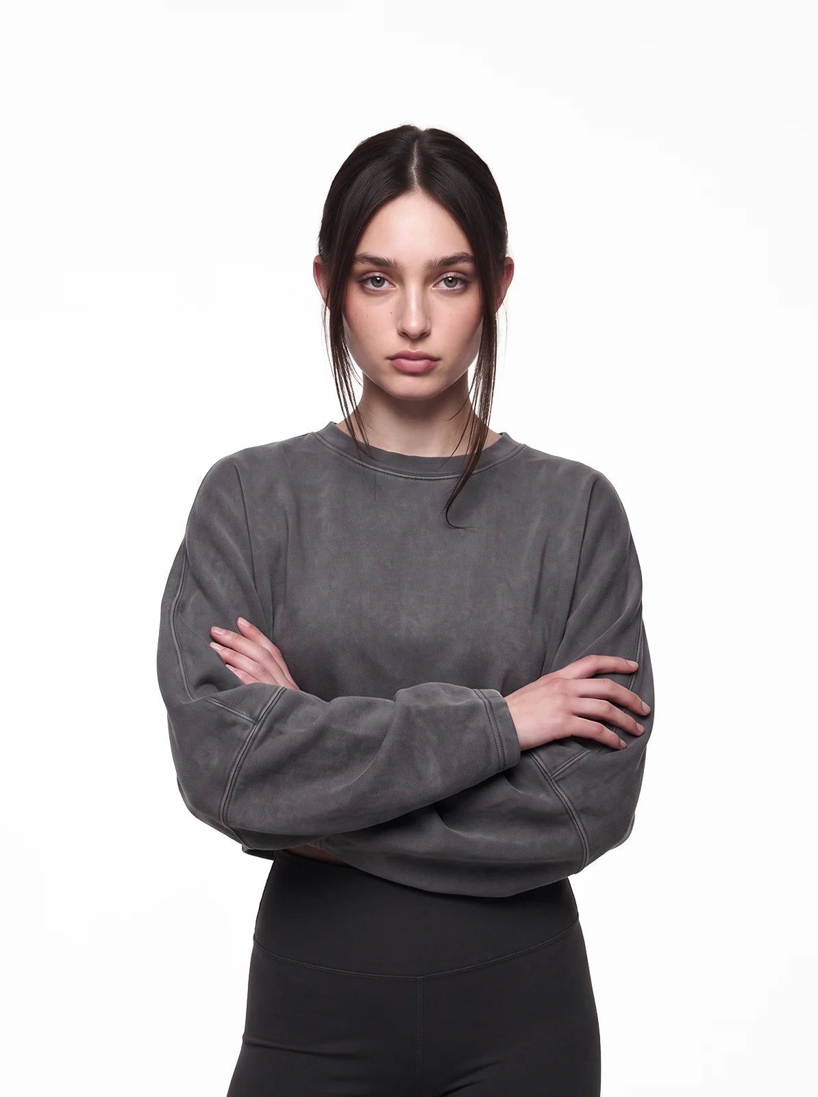 Woman wearing dark grey cult cover crop tee