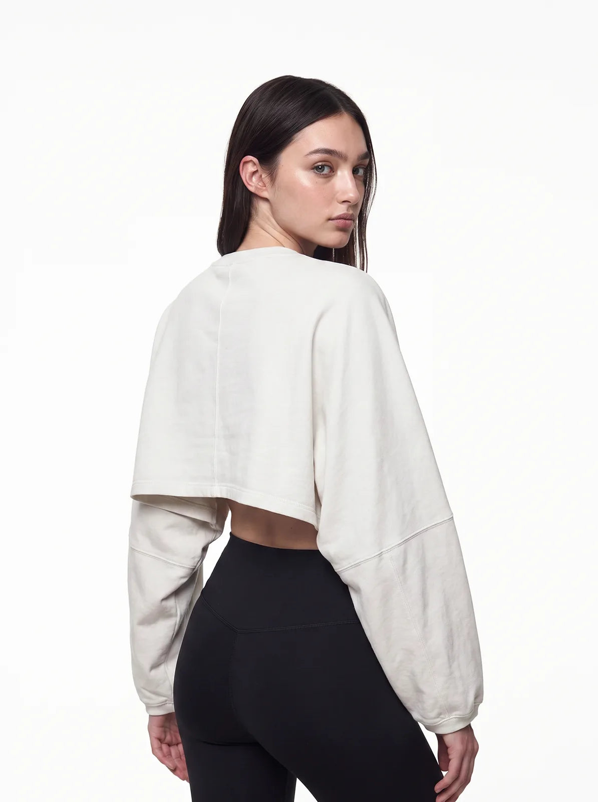 Woman wearing white cult cover crop tee