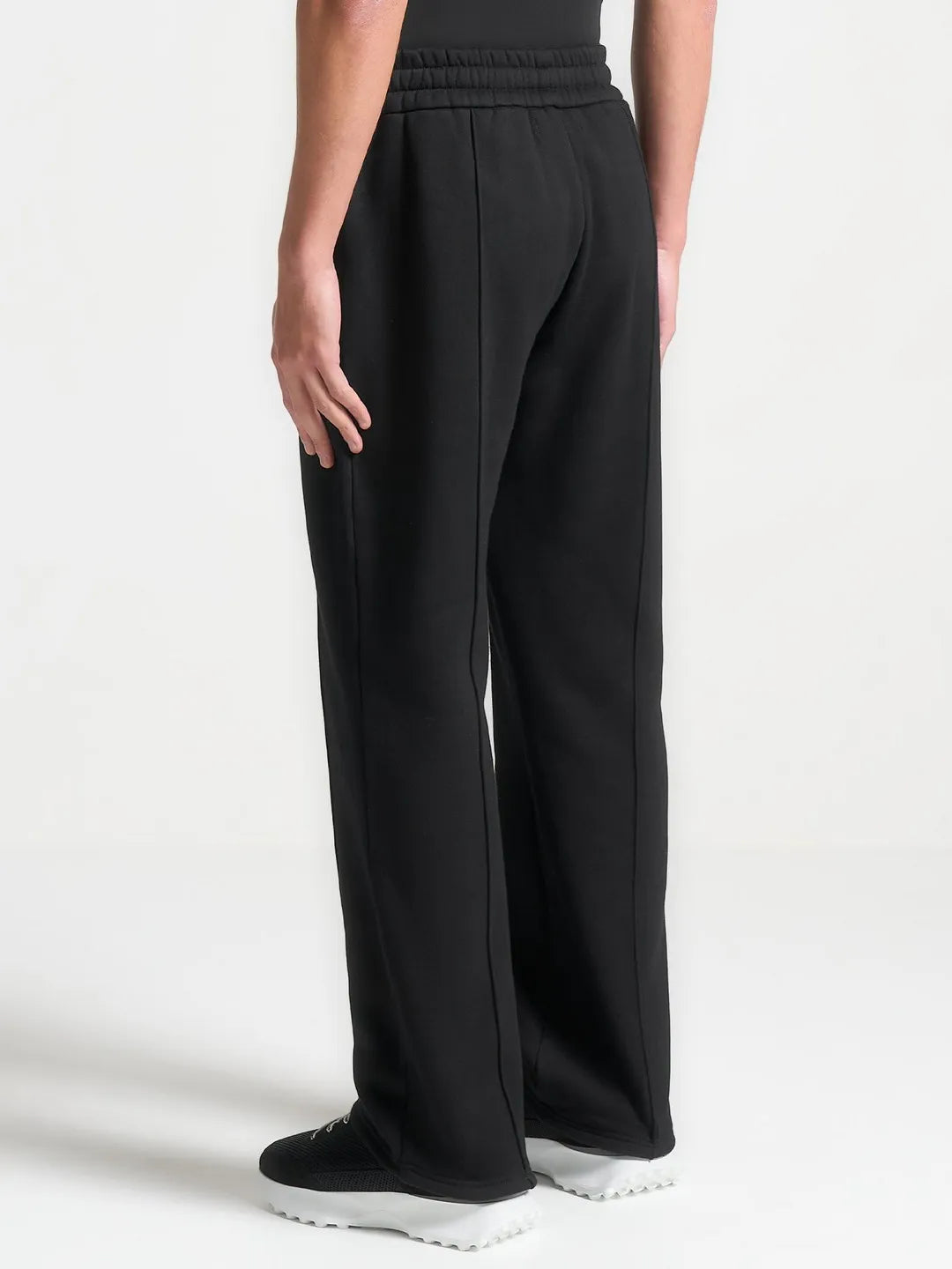 Black wide-leg pants worn by a person on a white background