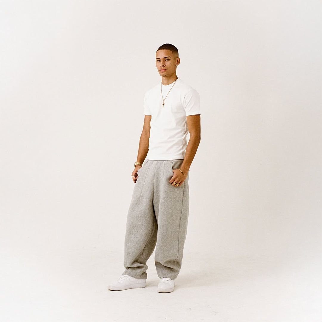 White short-sleeve T-shirt with loose gray sweatpants and white sneakers