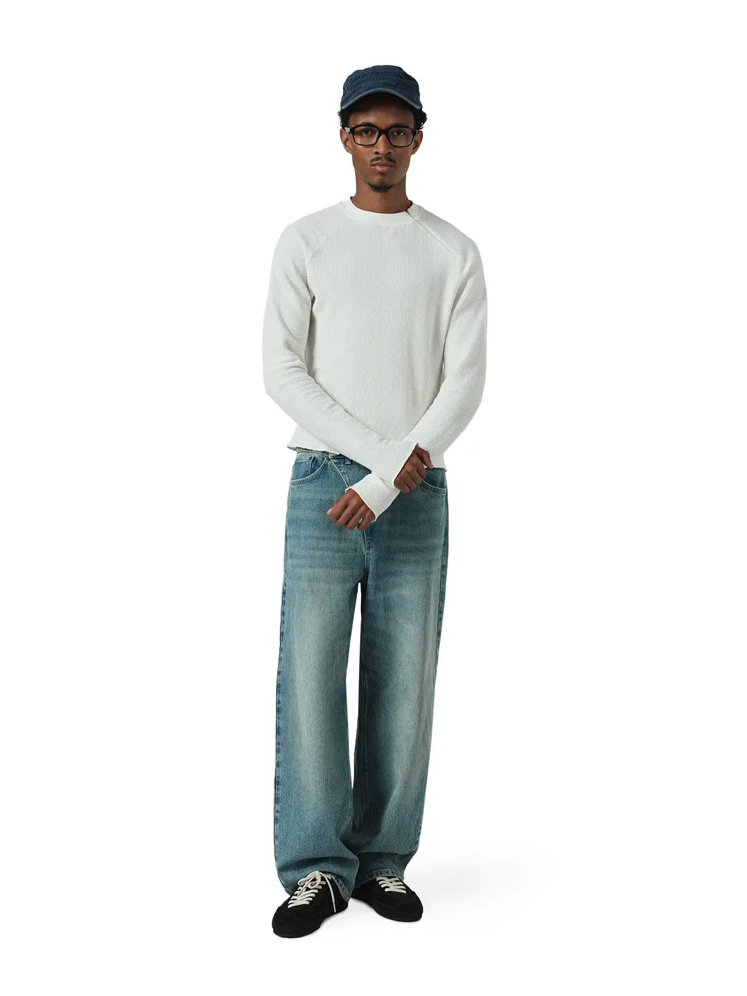 Man wearing a white t-shirt and blue blue pants on a white background