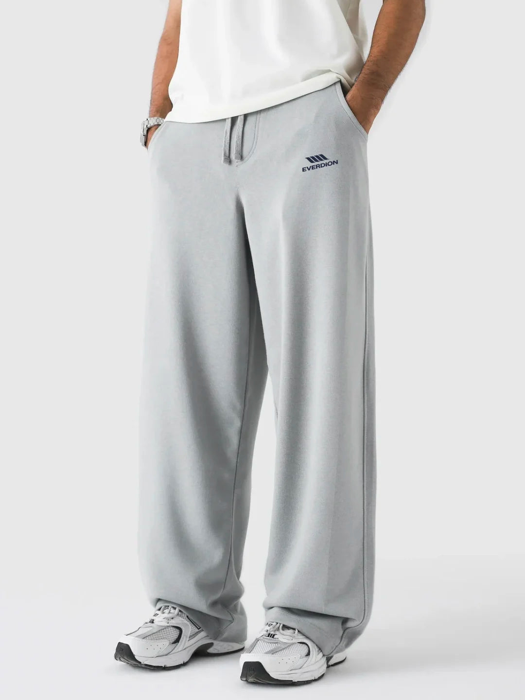 Person wearing grey pants on a white background
