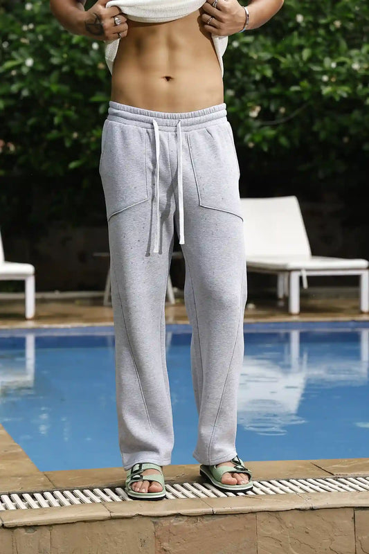 Person wearing gray sweatpants by a poolside