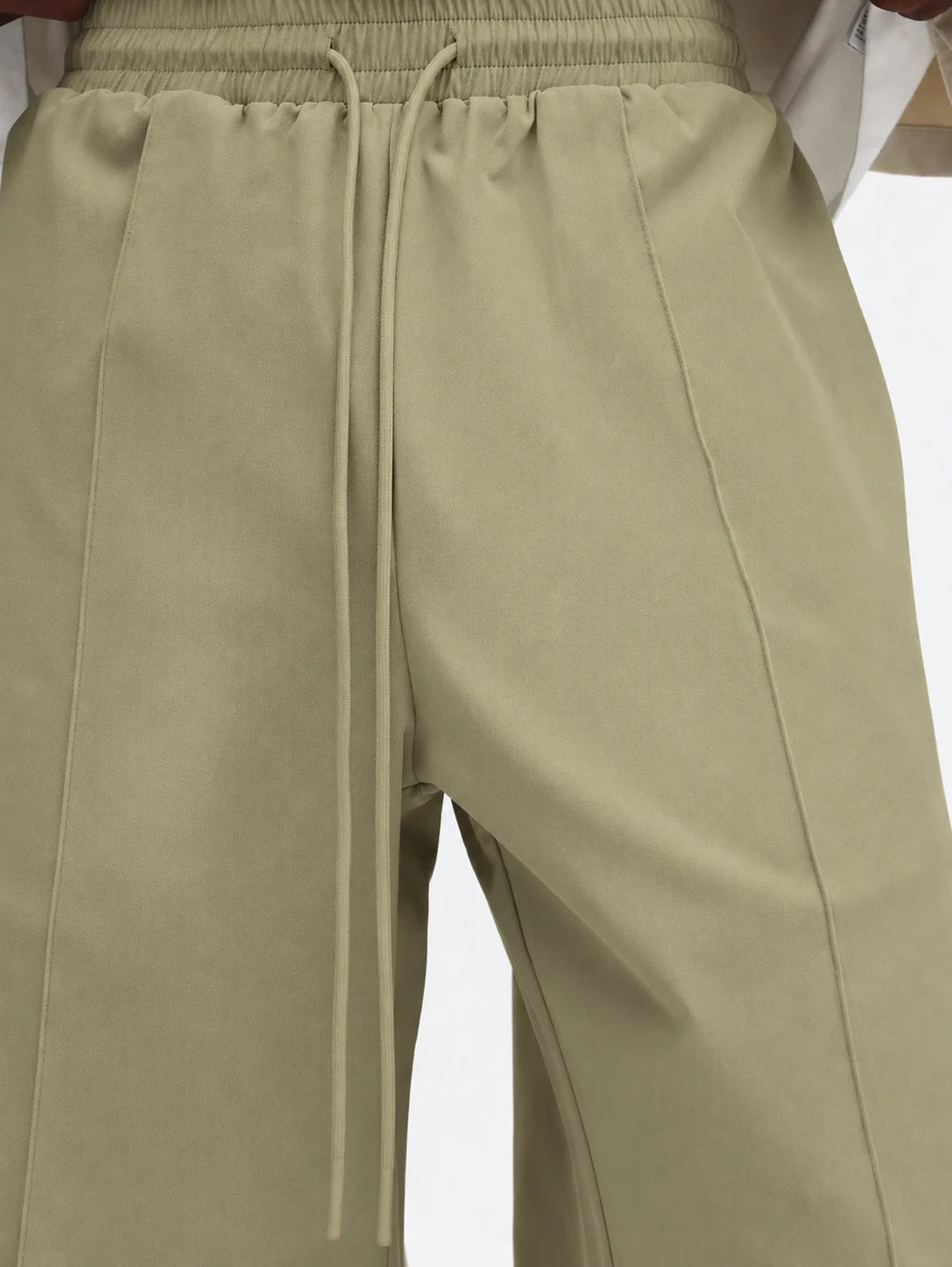 Beige pants with drawstring on a white background