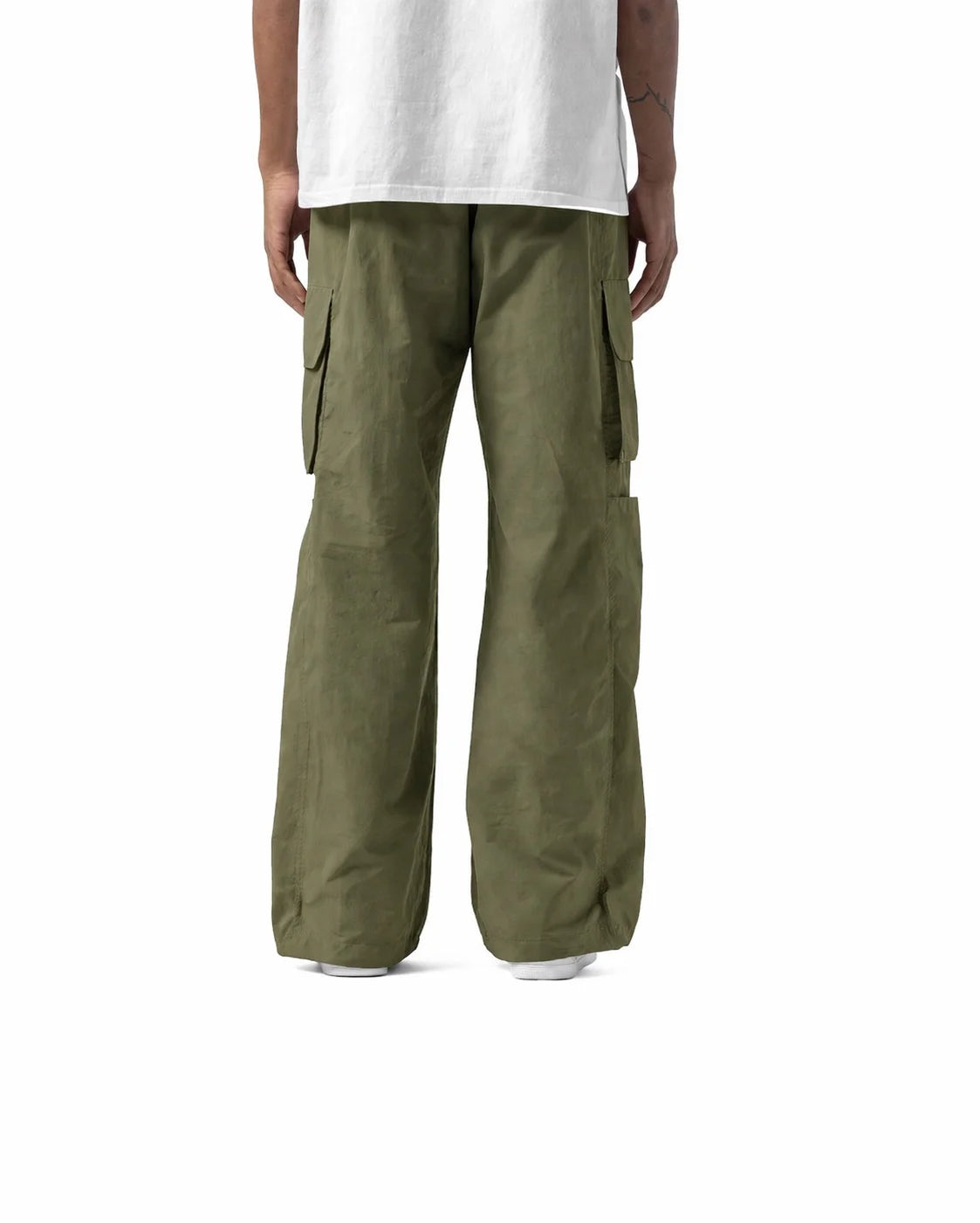 Person wearing olive green cargo pants on a white background