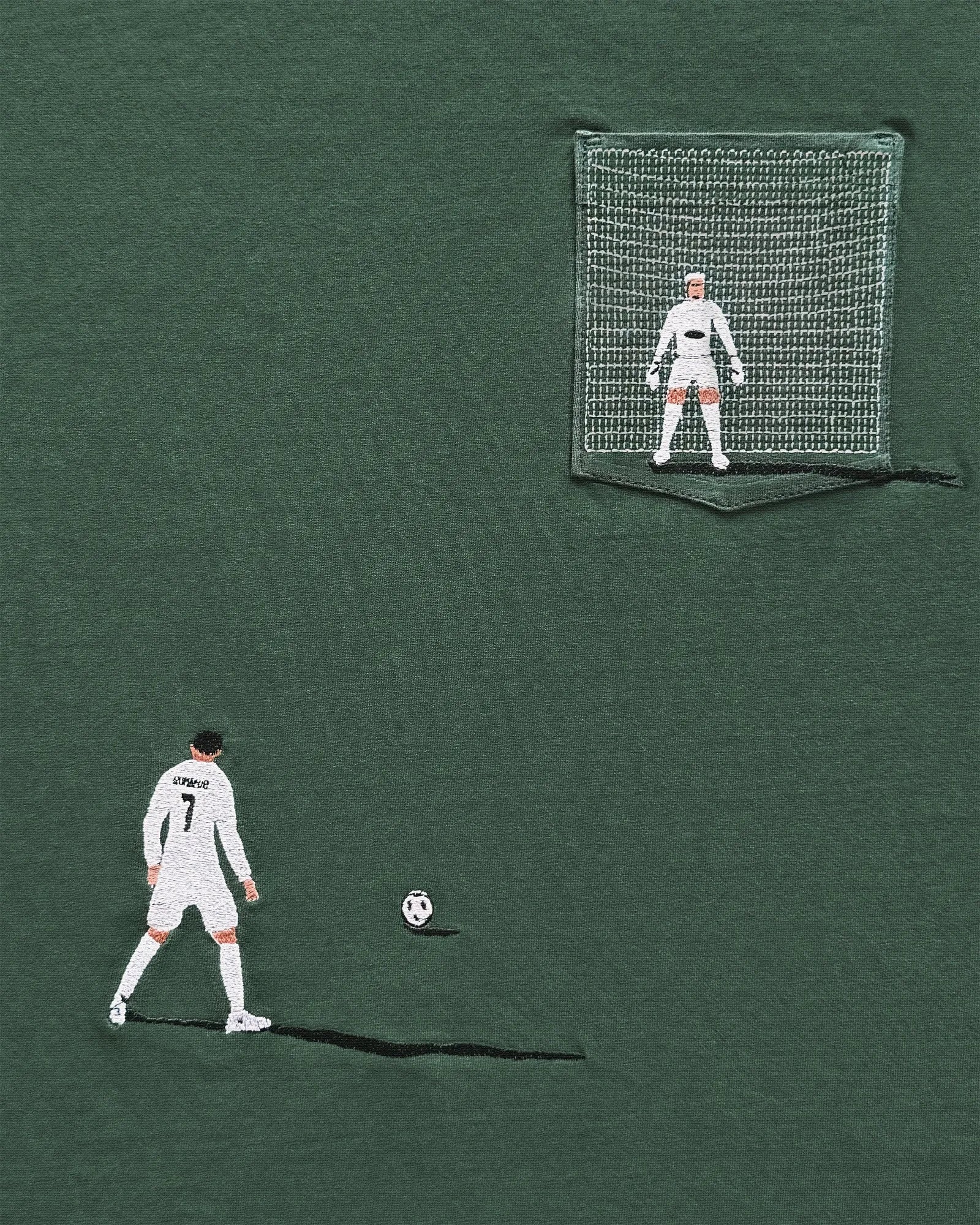 Green t-shirt with embroidered soccer player and goal design on a green background