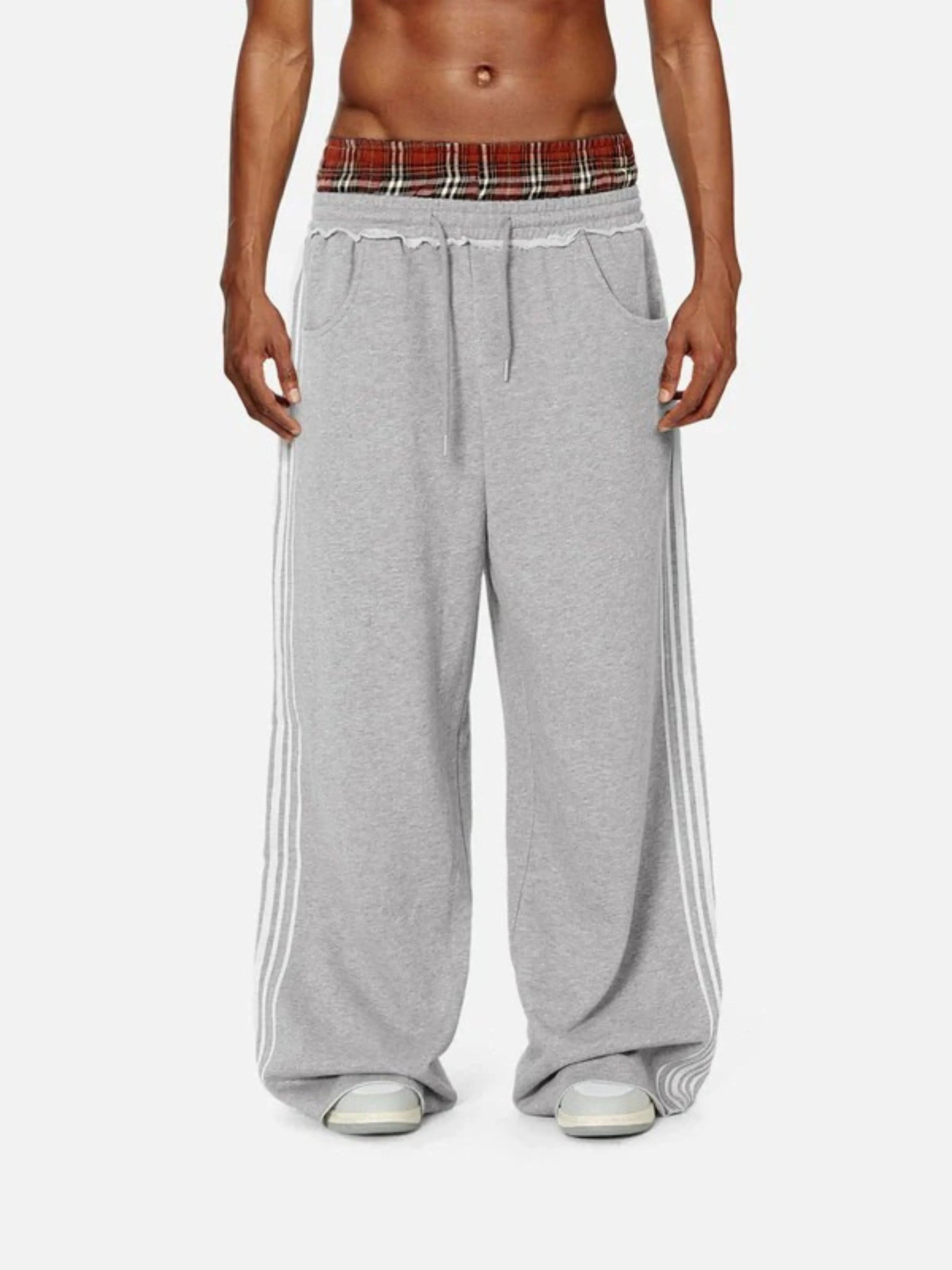 Person wearing grey boxer waist sweatpants 