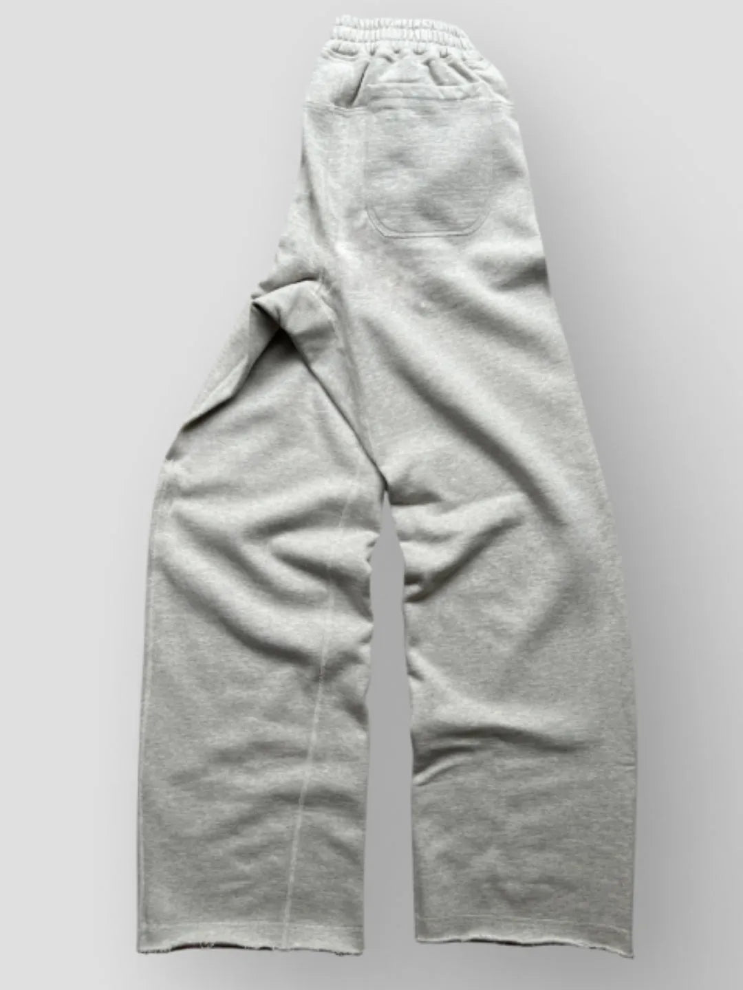 Person wearing button up grey sweatpants 