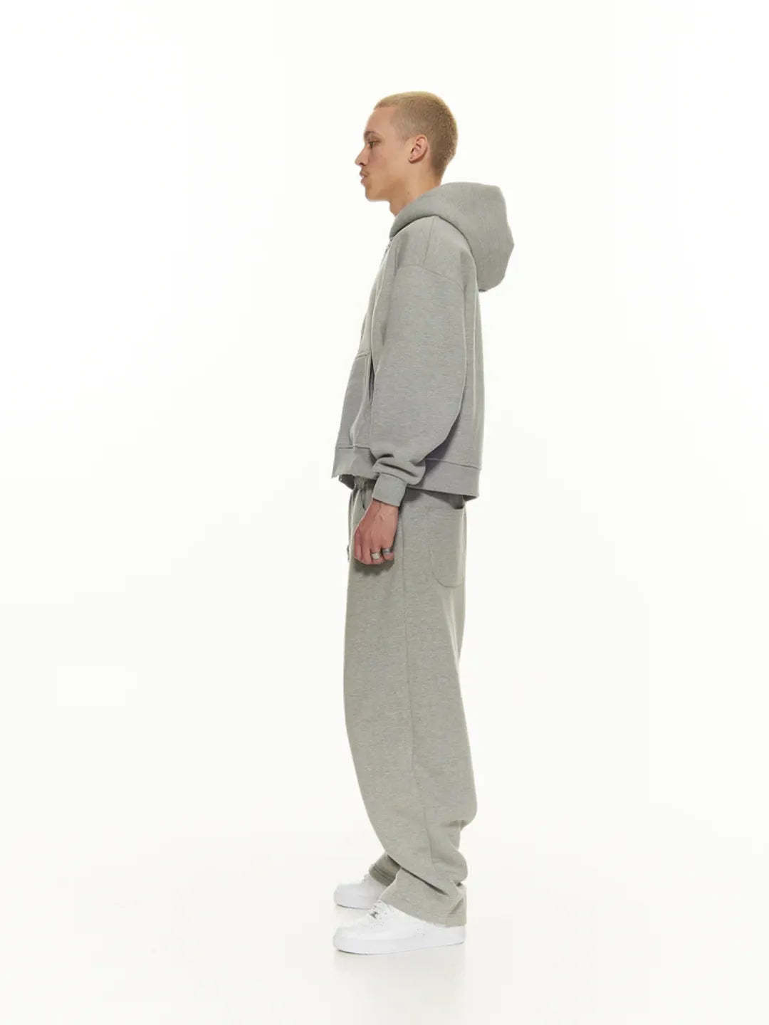 Person wearing a grey zip-up jacket