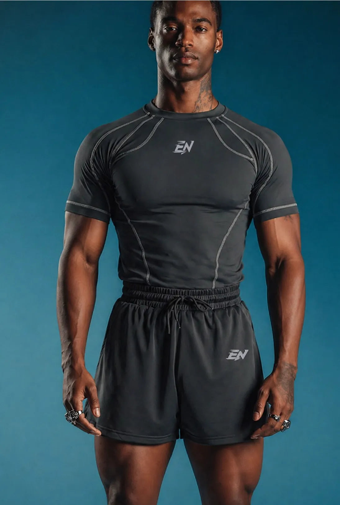 Person wearing black athletic t-shirt with brand logo on a blue background