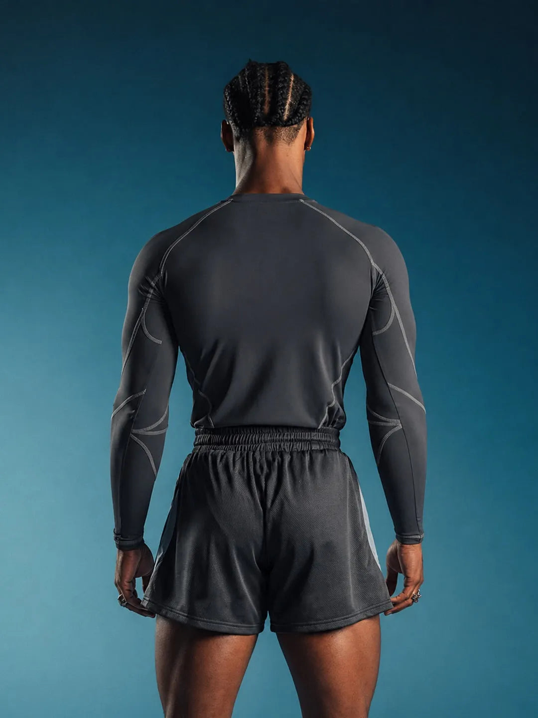 Person wearing a grey Compression Full Sleeve T-shirt with a brand logo 