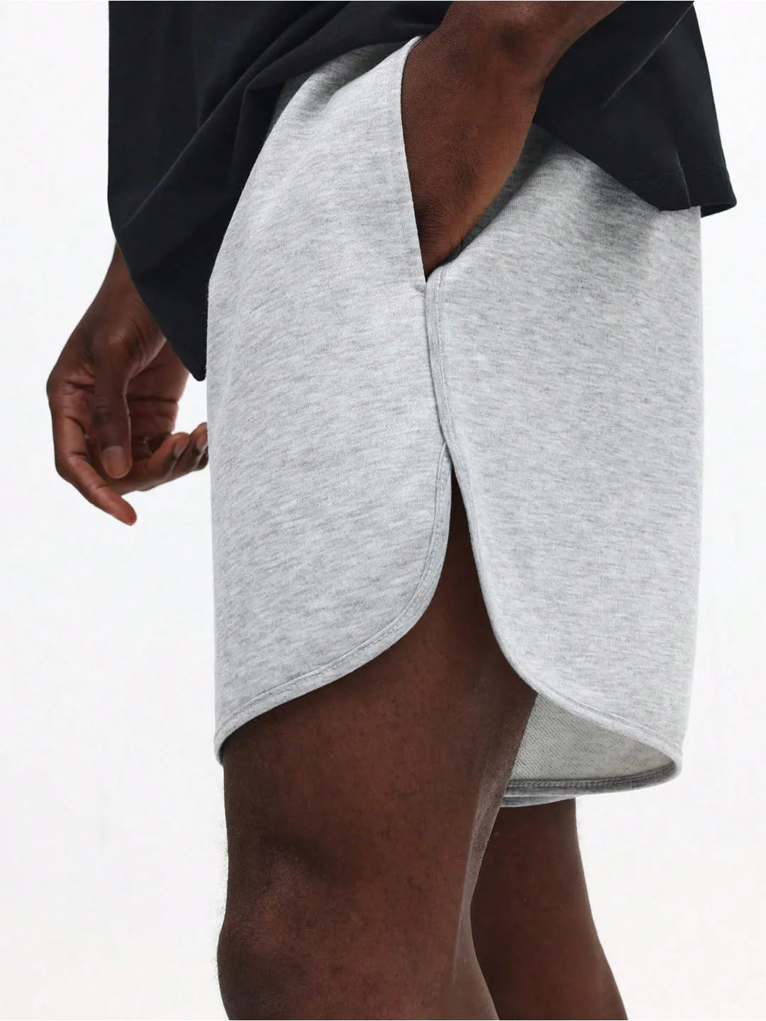 Grey shorts worn by a person on a white background