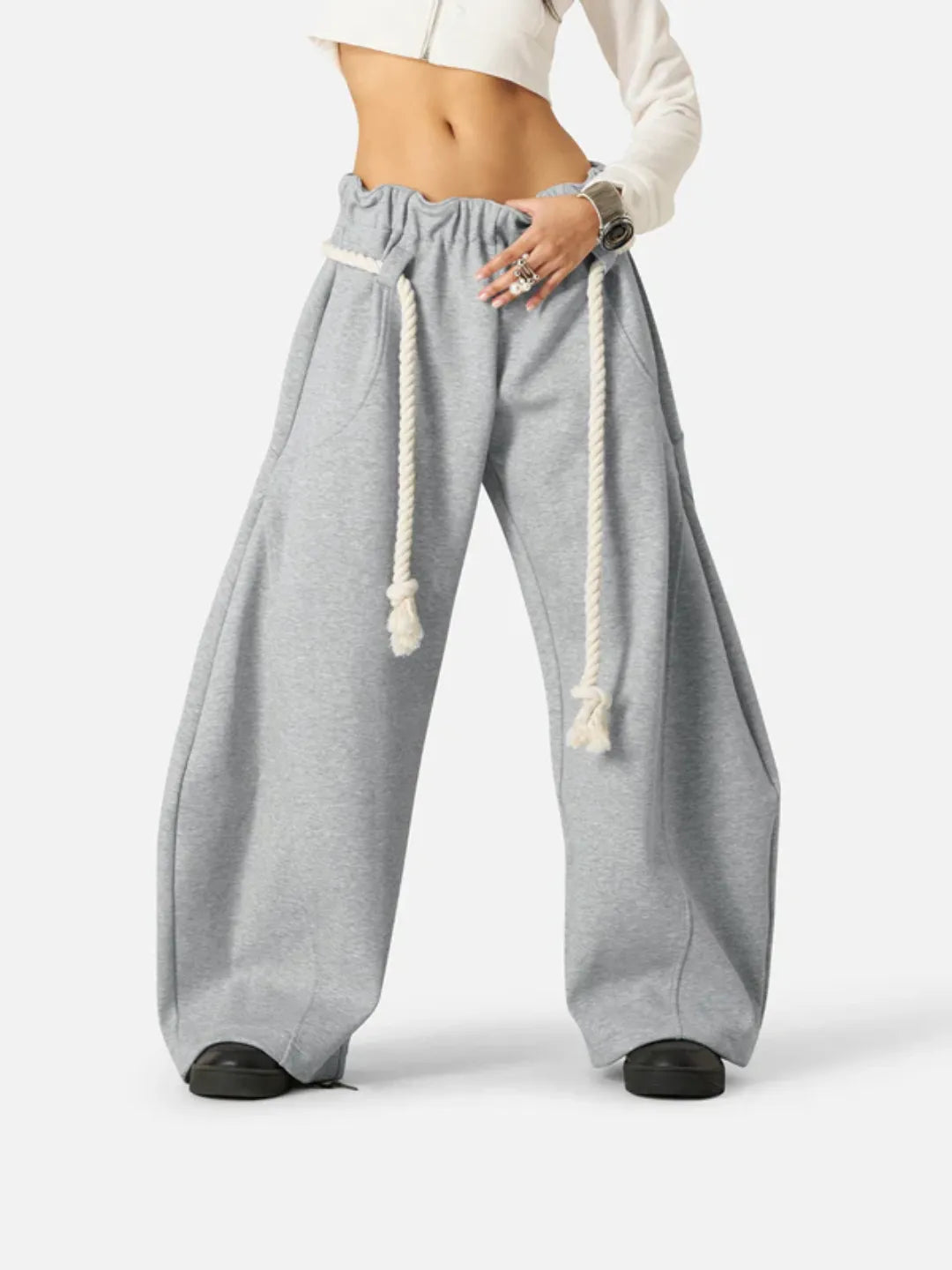 Grey wide-leg sweatpants with drawstrings on a white background