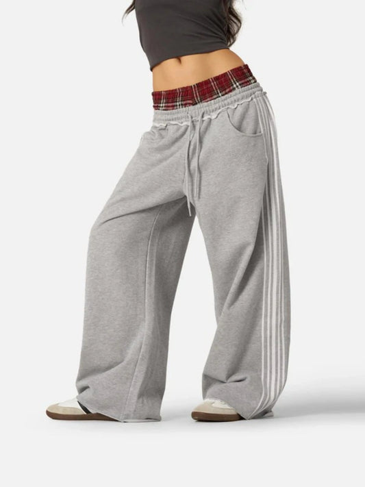 Person wearing grey boxer waist sweatpants 