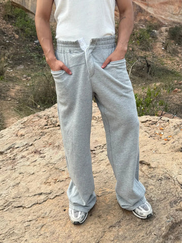 Person wearing button up grey sweatpants 