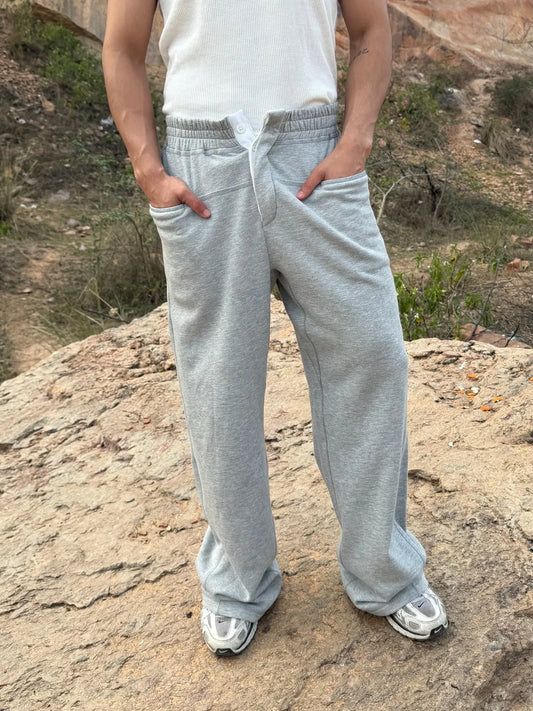 Person wearing button up grey sweatpants 