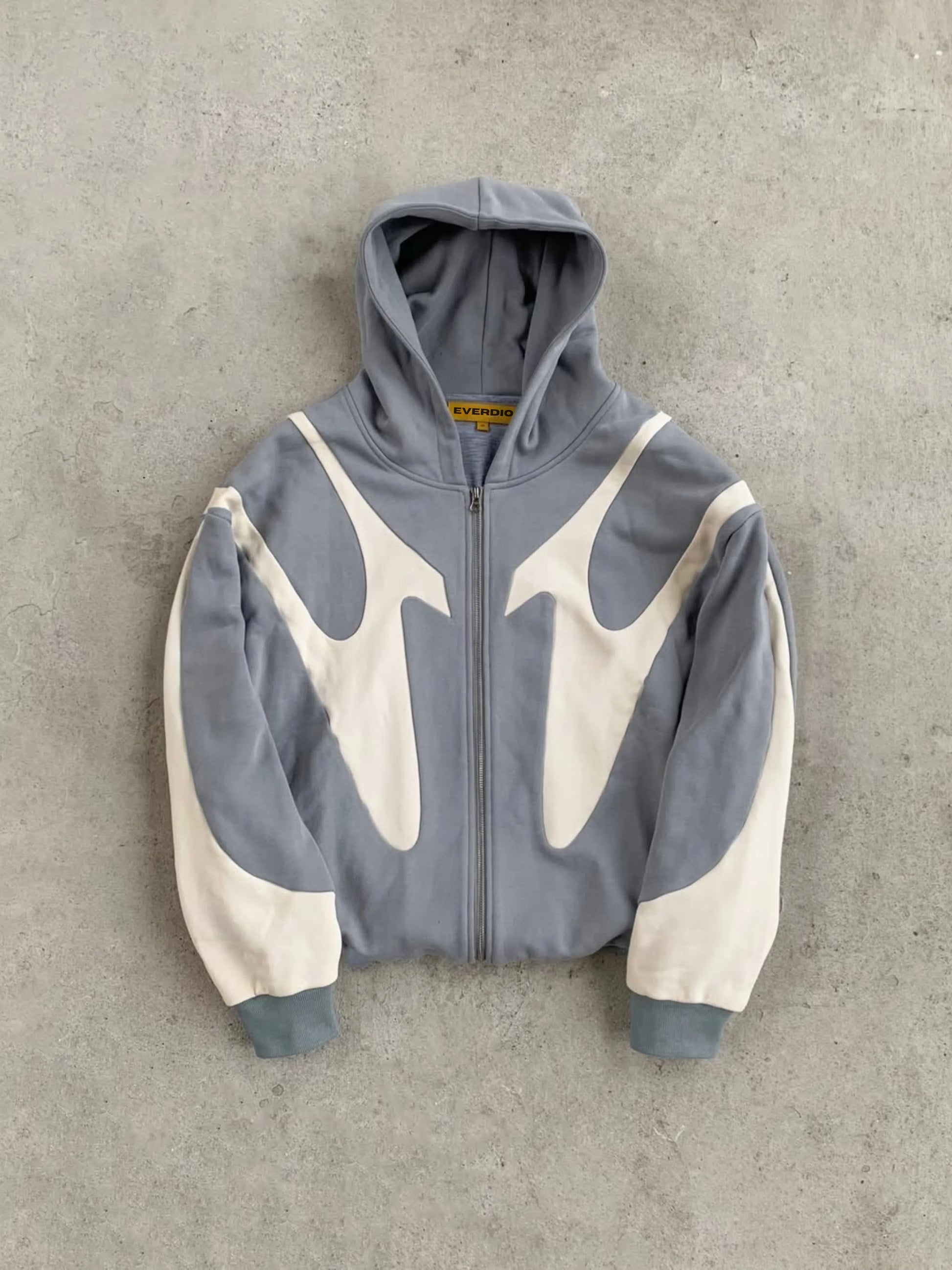 Grey and beige hoodie with a unique design on a gray background