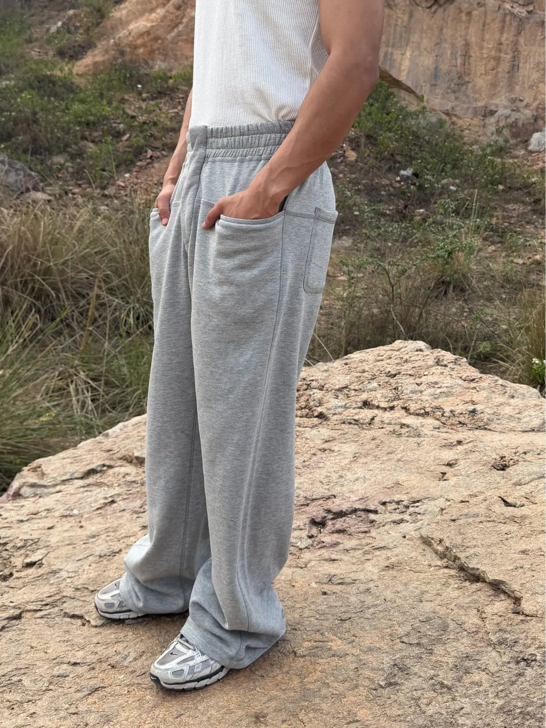 Person wearing button up grey sweatpants 