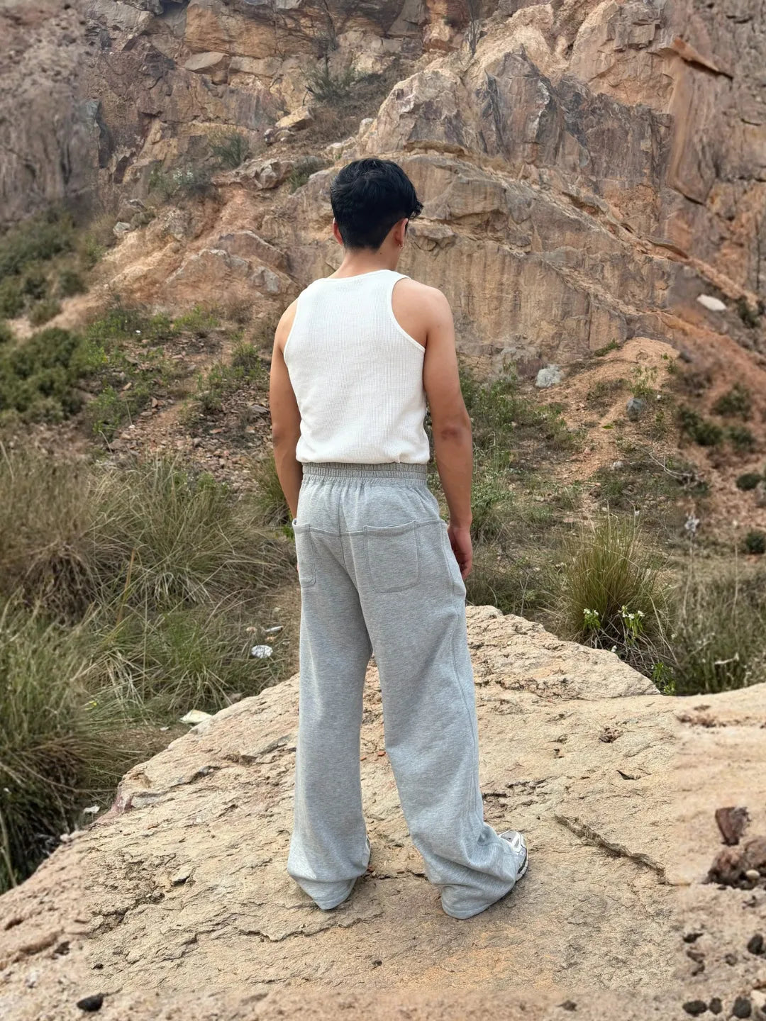 Person wearing button up grey sweatpants 